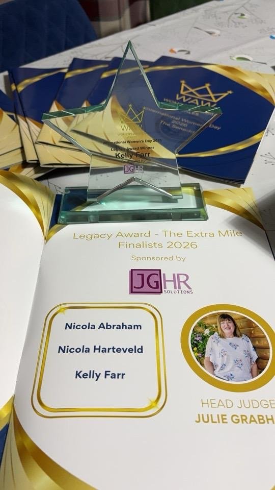 The Legacy Award trophy alongside the printed event brochure